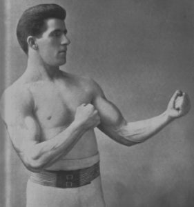 a black and white image of a muscular boxer